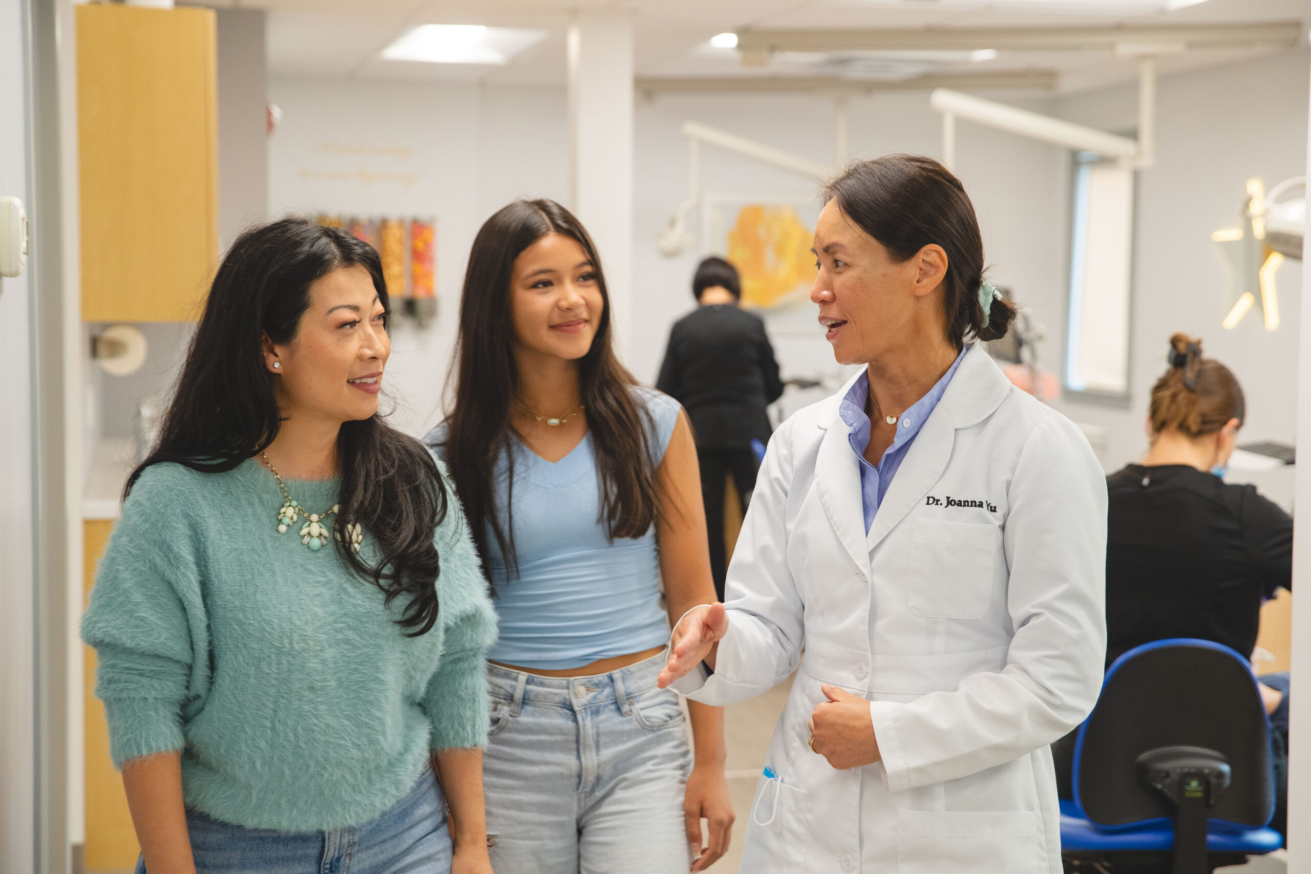 patient smiling with Dr. Yu during visit